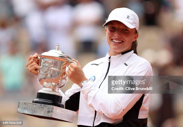 Iga Swiatek of Poland holds her winners trophy after victory against Karolina Muchova of Czech Republic in the Women's Singles Final match on Day...