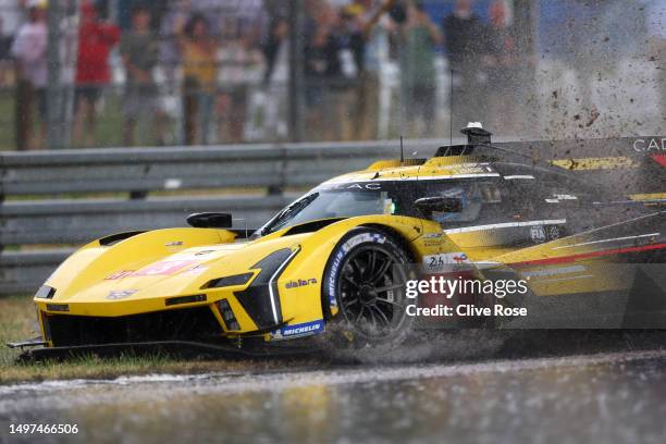 The Cadillac Racing Cadillac V-Series.R driven by Sebastien Bourdais, Renger van der Zande and Scott Dixon spins out during a heavy rain shower...