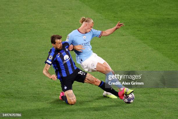 Francesco Acerbi of FC Internazionale battles for possession with Erling Haaland of Manchester City during the UEFA Champions League 2022/23 final...