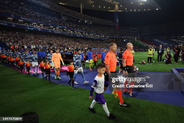 Referee Szymon Marciniak leads the teams out prior to the UEFA Champions League 2022/23 final match between FC Internazionale and Manchester City FC...