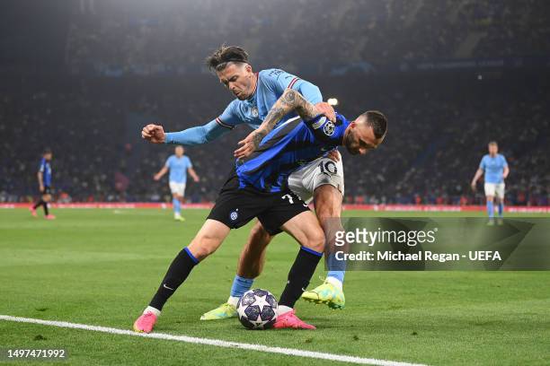 Jack Grealish of Manchester City battles for possession with Marcelo Brozovic of FC Internazionale during the UEFA Champions League 2022/23 final...