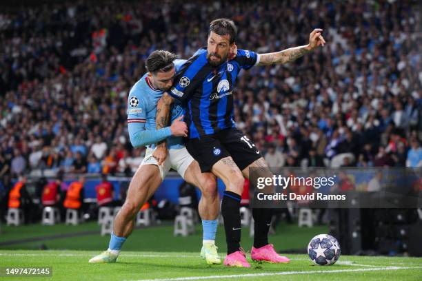 Francesco Acerbi of FC Internazionale holds off Jack Grealish of Manchester City during the UEFA Champions League 2022/23 final match between FC...