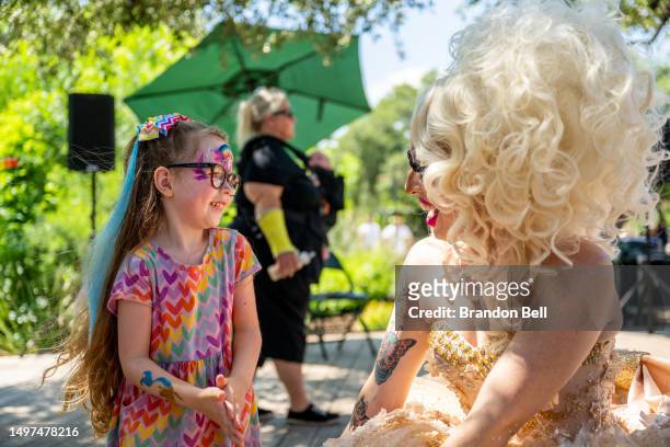 Keanya Philyan greets Austin Tx, drag queen Brigitte Bandit during a drag time story hour at the Waterloo Greenway park on June 10, 2023 in Austin,...