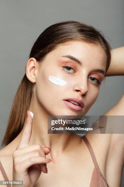 junge frau befeuchtet ihre haut, schönheitsporträt - skin beauty stock-fotos und bilder