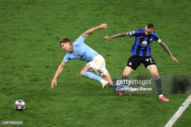 John Stones of Manchester City is tackled by Marcelo Brozovic of FC Internazionale during the UEFA Champions League 2022/23 final match between FC...