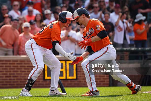 Gunnar Henderson of the Baltimore Orioles celebrates with Adley Rutschman after hitting a home run in the second inning against the Kansas City...