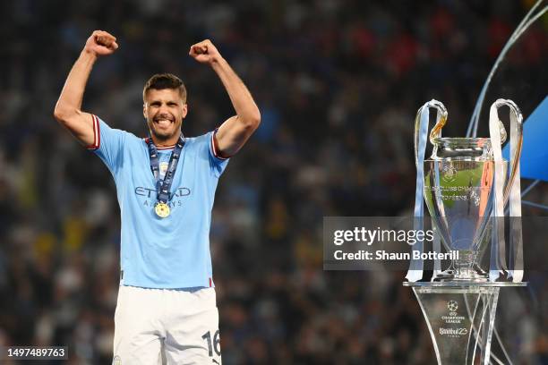 Rodri of Manchester City celebrates while wearing his winners medal next to the UEFA Champions League trophy after the team's victory in the UEFA...