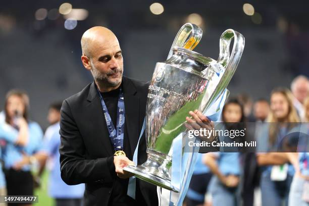 Pep Guardiola, Manager of Manchester City, celebrates with the UEFA Champions League trophy after the team's victory during the UEFA Champions League...