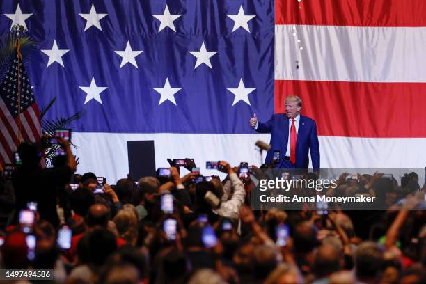 Former U.S. President Donald Trump walks offstage after his remarks at the Georgia state GOP convention at the Columbus Convention and Trade Center...