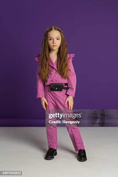 blonde girl in studio in purple suit on violet background. child. childhood. summer fashion. hairstyle - high fashion model poses stock pictures, royalty-free photos & images