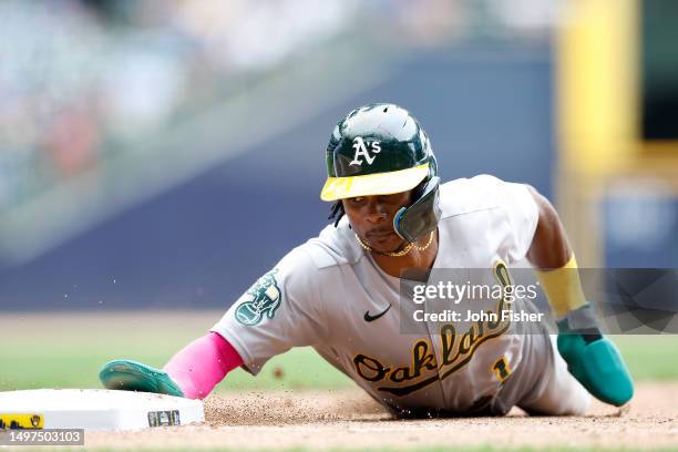 Esteury Ruiz of the Oakland Athletics slides safely back to first base in the eighth inning against the Milwaukee Brewers at American Family Field on...