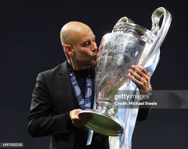 Pep Guardiola, Manager of Manchester City, kisses the UEFA Champions League trophy after the team's victory during the UEFA Champions League 2022/23...