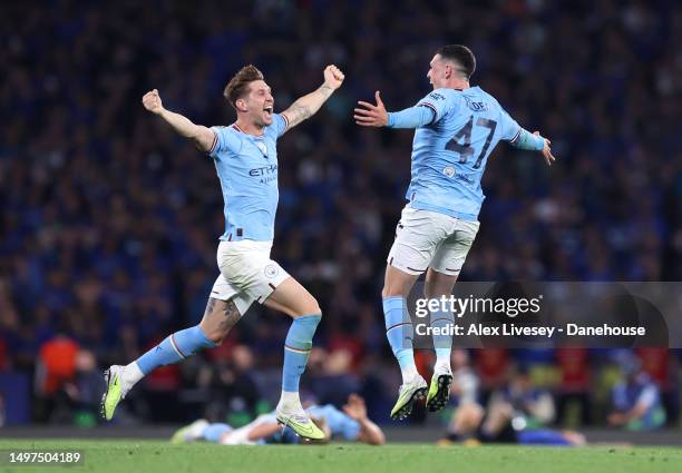 John Stones and Phil Foden of Manchester City celebrate at full time during the UEFA Champions League 2022/23 final match between FC Internazionale...