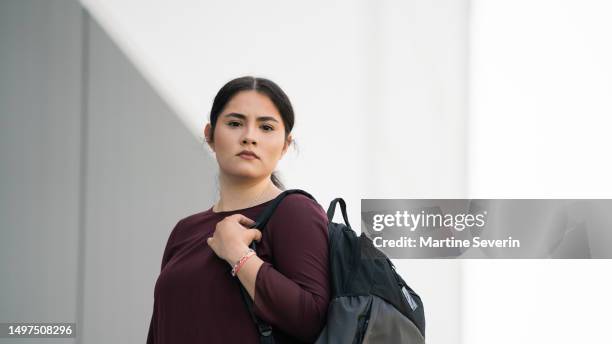 early twenties female and latino college grad arrives at the office on an early morning day. - mexican american stock pictures, royalty-free photos & images