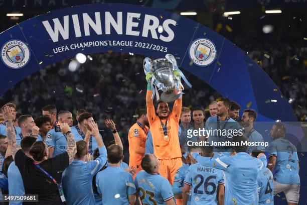 Ederson of Manchester City lifts the trophy as the team celebrates the 1-0 victory in the UEFA Champions League 2022/23 final match between FC...