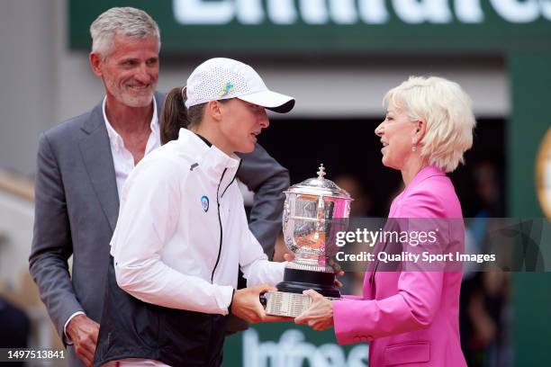 Iga Swiatek of Poland is presented with her winners trophy by Chris Evert after victory against Karolina Muchova of Czech Republic in the Women's...
