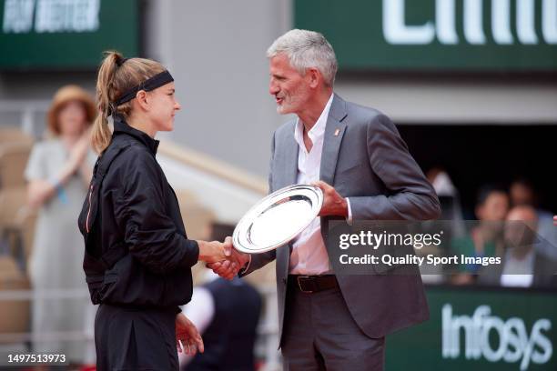 Karolina Muchova of Czech Republic receives the runner-up trophy from Gilles Moretton president of Tennis French Federation in the Women's Singles...