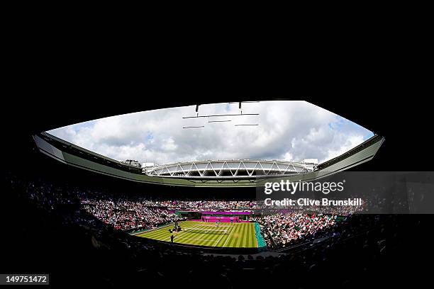 General view of Wimbledon is seen as Roger Federer of Switzerland returns a shot against Juan Martin Del Potro of Argentina in the Semifinal of Men's...