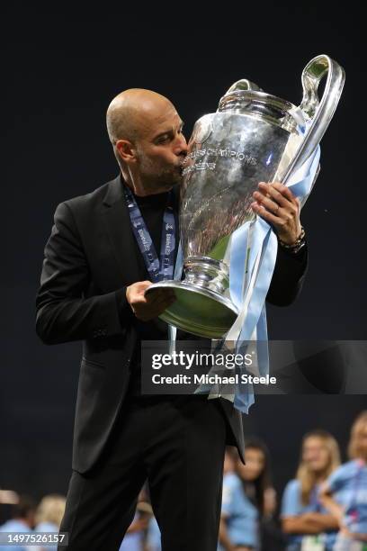 Pep Guardiola, Manager of Manchester City, kisses the UEFA Champions League trophy after the team's victory during the UEFA Champions League 2022/23...