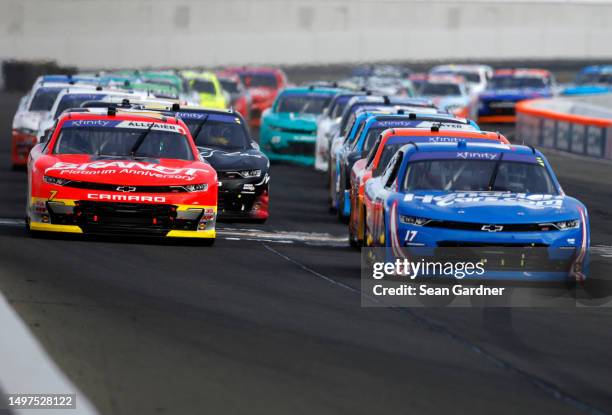 Kyle Larson, driver of the HendrickCars.com Chevrolet, and Justin Allgaier, driver of the BRANDT Chevrolet, lead the field during the NASCAR Xfinity...