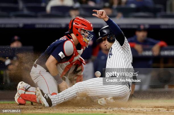 Isiah Kiner-Falefa of the New York Yankees scores a run in the seventh inning as Reese McGuire of the Boston Red Sox can't come up with the ball at...