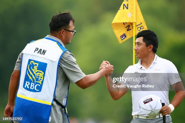 Pan of Chinese Taipei celebrates with his caddie after his round on the 18th hole during the third round of the RBC Canadian Open at Oakdale Golf &...