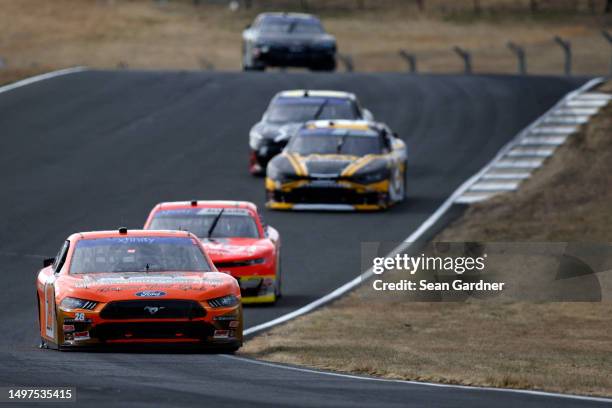 Aric Almirola, driver of the Michael Roberts Construction Ford, leads the field during the NASCAR Xfinity Series DoorDash 250 at Sonoma Raceway on...