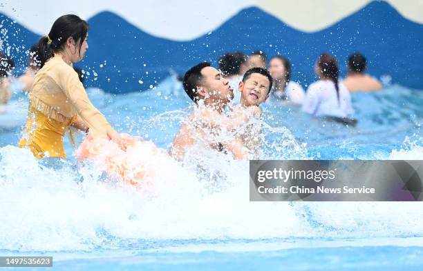 People have fun at a water park to escape summer heat on June 10, 2023 in Chongqing, China.