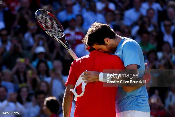 Roger Federer of Switzerland is congratulated by Juan Martin Del Potro of Argentina after his 4-6, 7-6, 19-17 win in the Semifinal of Men's Singles...