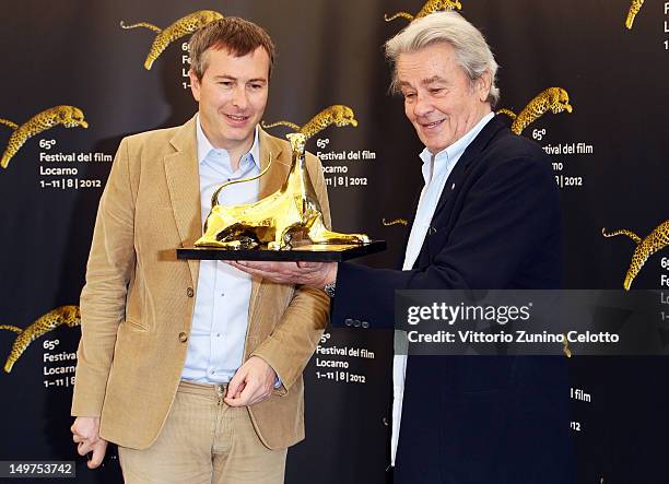 Olivier Pere and Alain Delon attend Life Achievement Award photocall during the 65th Locarno Film Festival on August 3, 2012 in Locarno, Switzerland.