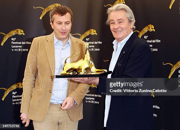 Olivier Pere and Alain Delon attend Life Achievement Award photocall during the 65th Locarno Film Festival on August 3, 2012 in Locarno, Switzerland.
