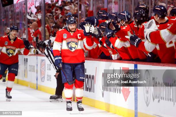Aleksander Barkov of the Florida Panthers is congratulated by his teammates at the bench after scoring a goal against the Vegas Golden Knights during...