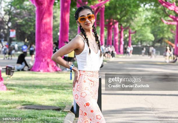Deysy is seen wearing a white top, white and orange pants, orange sunglasses during Governors Ball Music Festival 2023 at Flushing Meadows Corona...