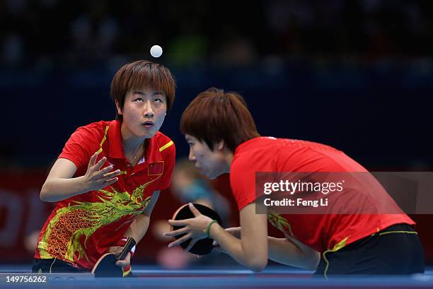 Ning Ding and Xiaoxia Li of China competes during Women's Team Table Tennis first round match against team of Spain on Day 7 of the London 2012...