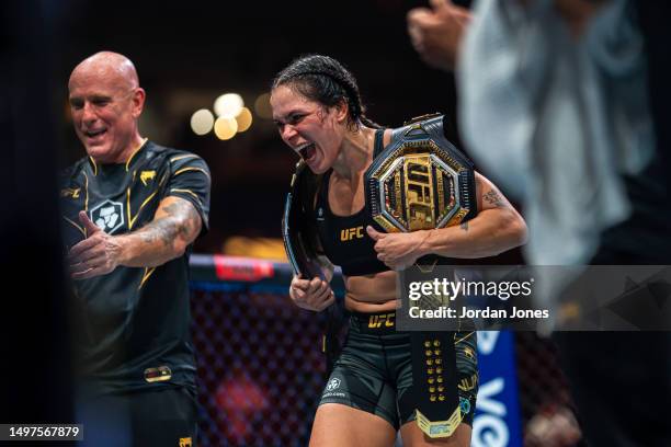 Amanda Nunes takes one last celebration with her titles after announcing her retirement during the UFC 289 event at Rogers Arena on June 10, 2023 in...