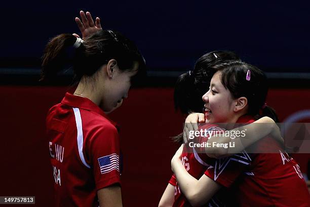Ariel Hsing hugs Lily Zhang of United States after Women's Team Table Tennis first round match against team of Japan on Day 7 of the London 2012...