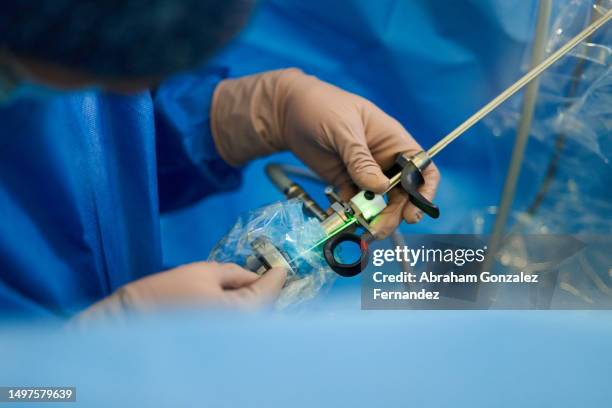 doctor inserting laser into endoscopic tube - endoscope stock pictures, royalty-free photos & images