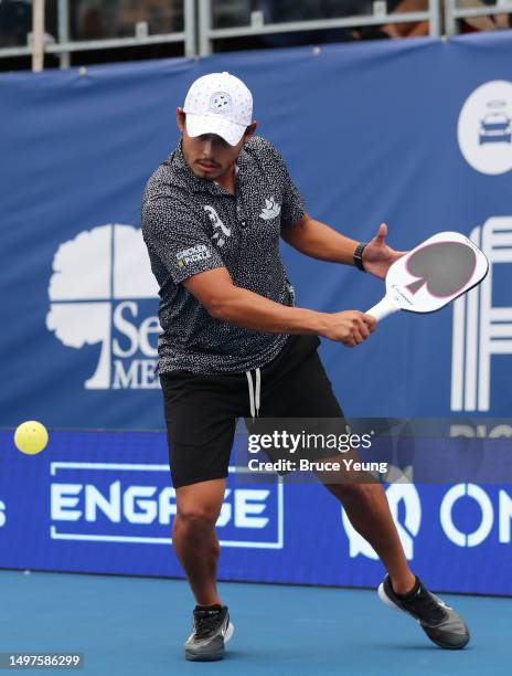 Daniel de la Rosa hits a backhand slice shot against Pesa Teoni and Patrick Kawka during the PPA Pro Men's Doubles division at Life Time Rancho San...