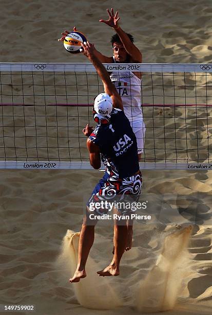 Todd Rogers of the United States has his shot blocked by Paolo Nicolai of Italy during the Men's Beach Volleyball Round of 16 match between United...