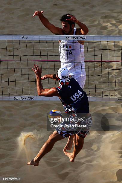 Todd Rogers of the United States has his shot blocked by Paolo Nicolai of Italy during the Men's Beach Volleyball Round of 16 match between United...