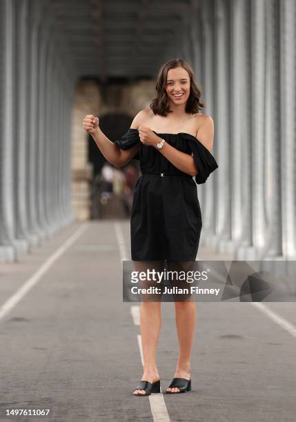Iga Swiatek of Poland pretends to celebrate with the trophy on the Bir-Hakeim bridge after winning the Women's Singles title on June 11, 2023 in...