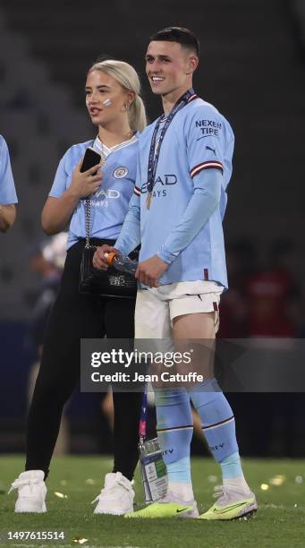 Phil Foden of Manchester City celebrates with Rebecca Cooke after the team's victory in the UEFA Champions League 2022/23 final match between FC...