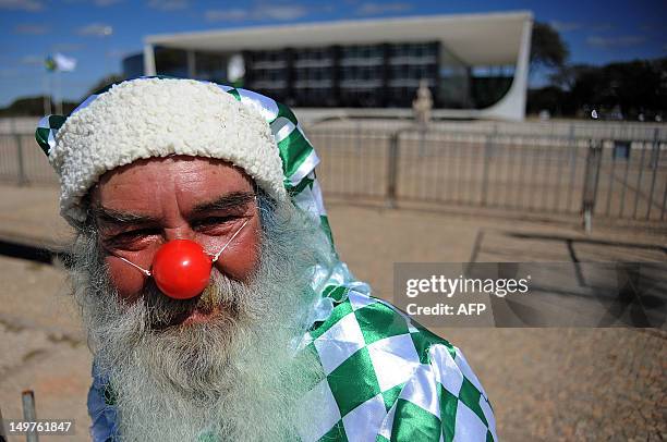 Demonstrator dressed like a clown protest in front of the Supreme Court, where the trial known as 'mensalao' is being held, in Brasilia, Brazil, on...