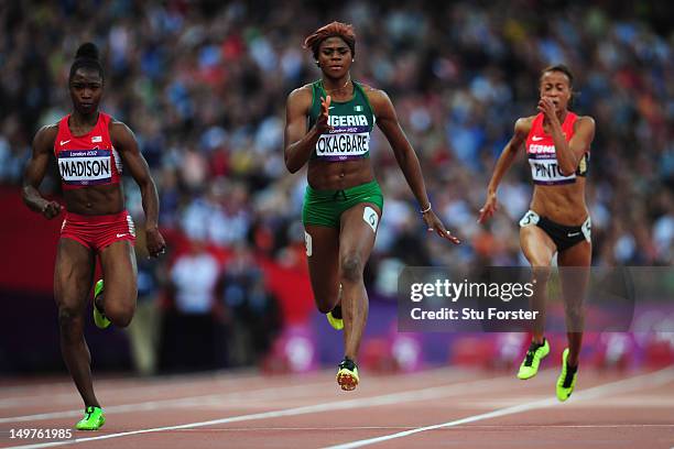 Tianna Madison of the United States, Blessing Okagbare of Nigeria and Tatjana Pinto of Germany compete in the Women's 100m Round 1 Heats on Day 7 of...