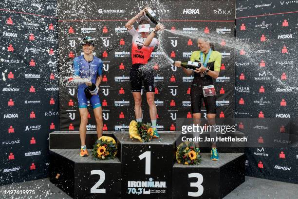 Ashleigh Gentle of Australia, Daniela Ryf of Switzerland and Anne Reischmann of Germany pose for a picture during the flower ceremony of the IRONMAN...