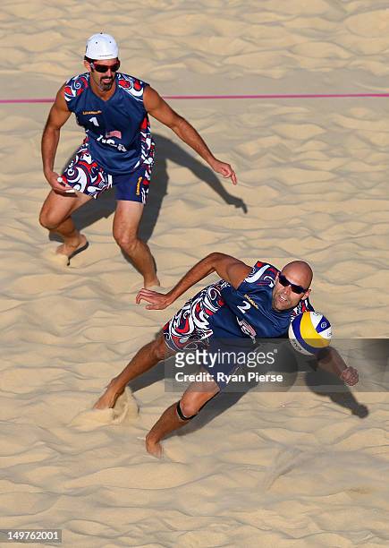 Phil Dalhausser of the United States dives for the ball as Todd Rogers of the United States looks on during the Men's Beach Volleyball Round of 16...