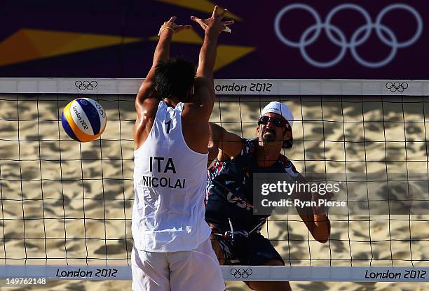 Todd Rogers of the United States has his shot blocked by Paolo Nicolai of Italy during the Men's Beach Volleyball Round of 16 match between United...