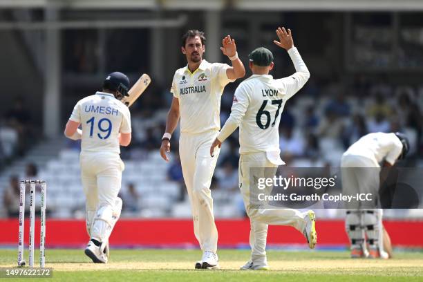 Mitchell Starc of Australia celebrates the wicket of Umesh Yadav of India with teammate Nathan lyon during day five of the ICC World Test...