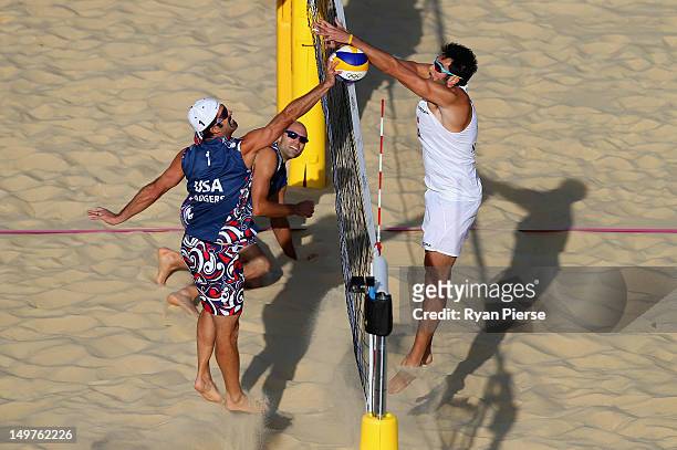 Todd Rogers of the United States has his shot blocked by Paolo Nicolai of Italy during the Men's Beach Volleyball Round of 16 match between United...