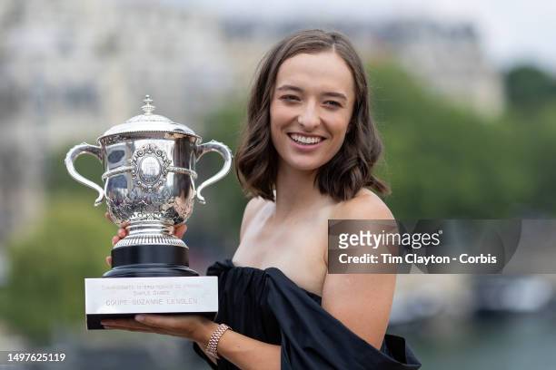 Iga Swiatek of Poland the Women's Singles Final 2023 winner during a photo shoot with the winner's trophy on the Bir-Hakeim bridge during the 2023...